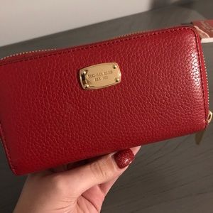 Michael Kors red leather zip wallet.